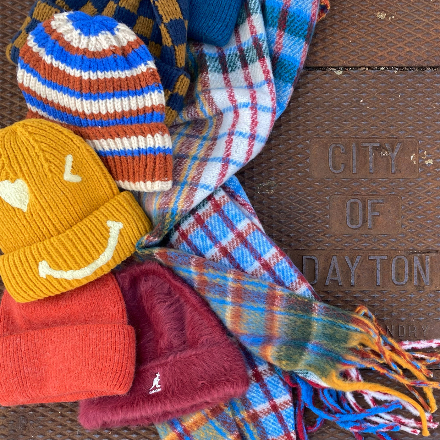 Five colorful and fun beanies with a bright plaid scarf