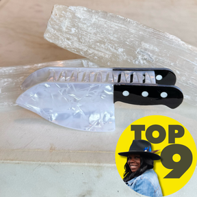 Knife Hair Clip designed to resemble a kitchen knife with a pearlescent blade and black handle with white dots, stylish and unique hair accessory.