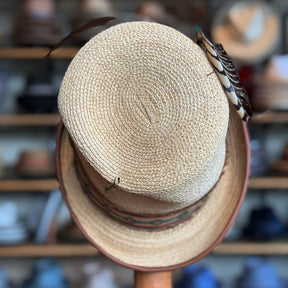 Luna Straw Top Hat with woven natural straw material, decorative feather accents, and a patterned band, perfect for stylish accessory lovers.