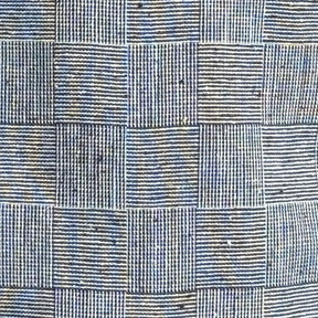Close-up detail of textured fabric in a subtle checkered pattern on a Monochrome Vintage Flat Cap, showcasing fine stitching and a classic newsboy style design.