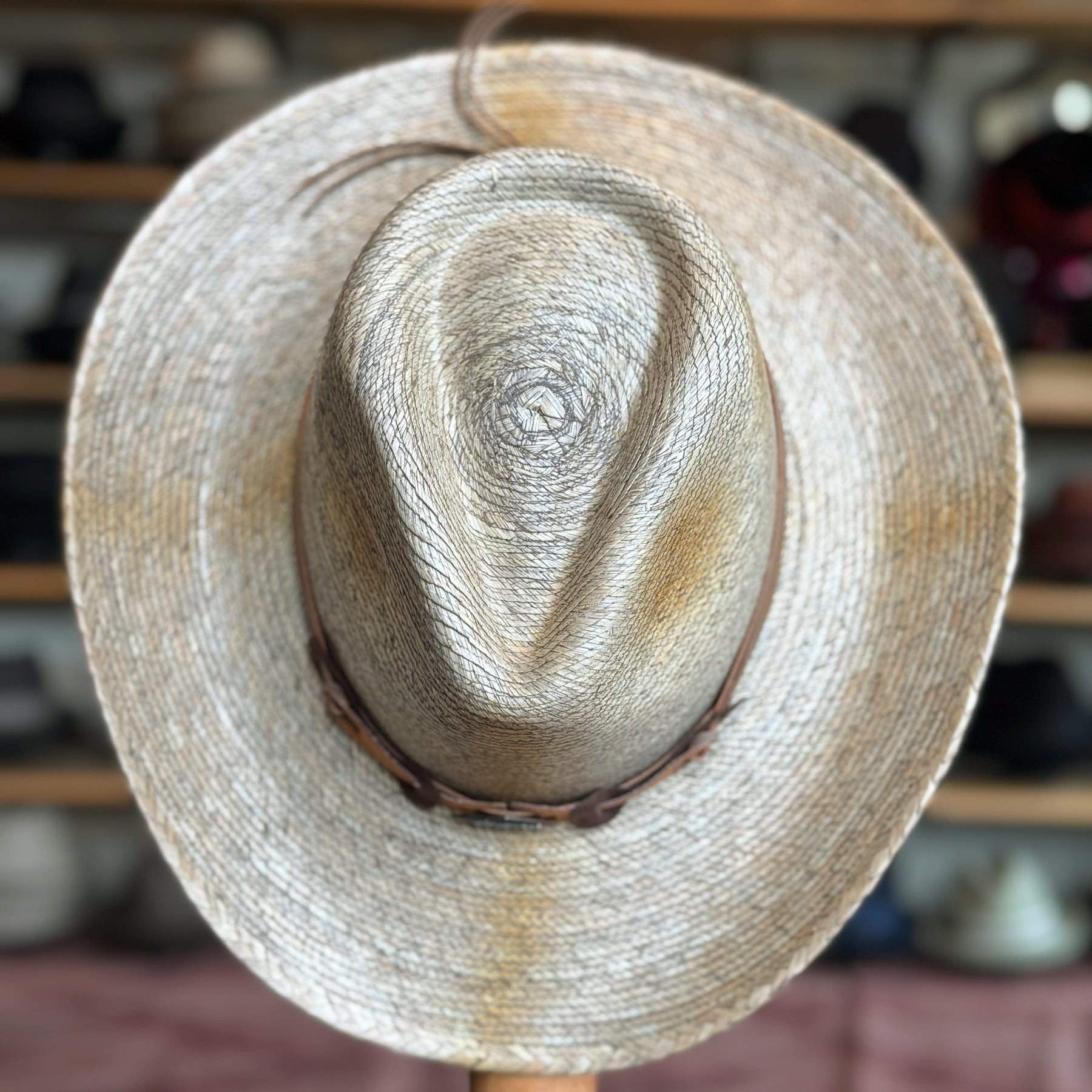 Monterrey Bay straw hat with a wide brim and a woven leather band, ideal for sun protection and stylish outdoor wear.