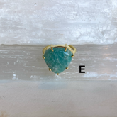 Prong Ring featuring a triangular green gemstone set in a delicate gold band, highlighting a vintage-inspired, elegant design.