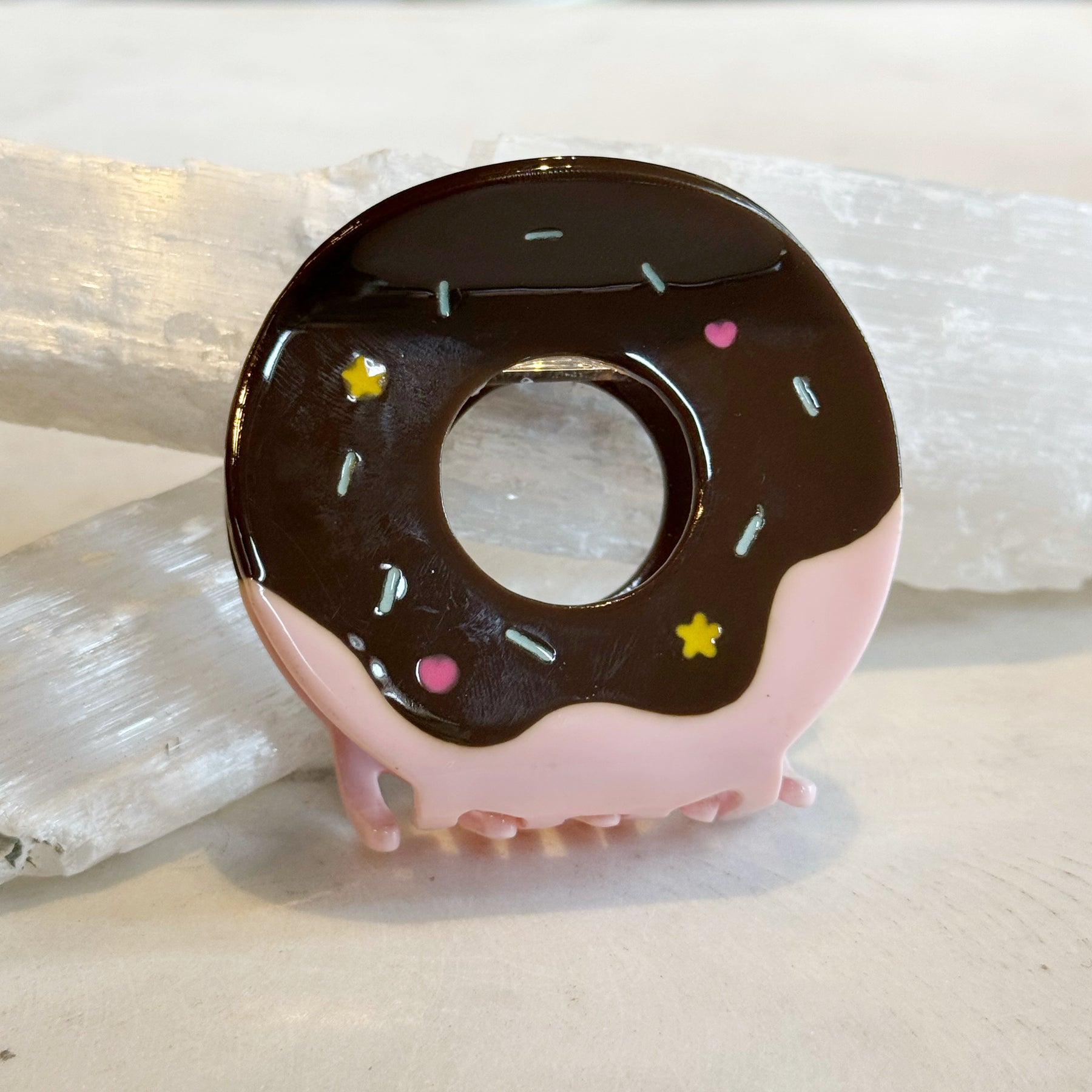 Donut Hair Clip designed to look like a chocolate and pink frosted donut with colorful sprinkles, providing a playful and stylish hair accessory.