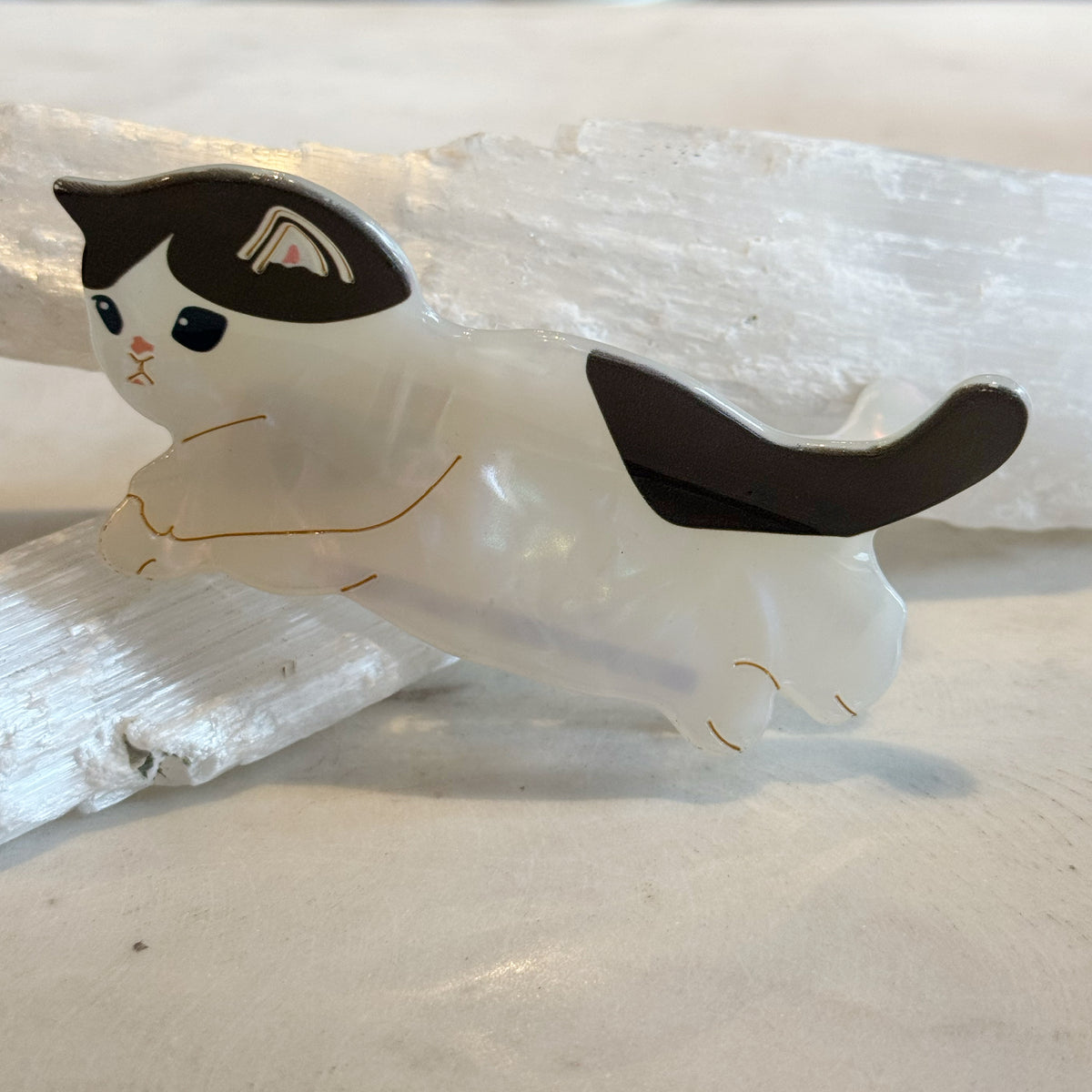 Kitty Hair Clip designed as a playful white and black cat with delicate gold accents, ideal for adding a charming touch to hairstyles.