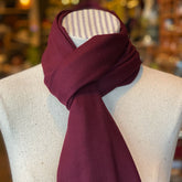 Simple Scarf in a rich burgundy color wrapped neatly around a mannequin neck, showcasing a cozy and elegant accessory perfect for layering in cooler weather.